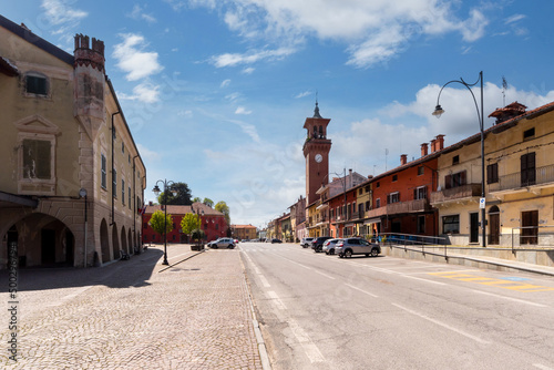Villafalletto, Cuneo, Italy - April 15, 2022: piazza Giuseppe Mazzini, the central square of Villafalletto with the civic tower and the town hall on the left