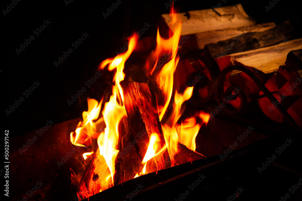 Fototapeta premium Mountain summer. Bonfire in night. Black background