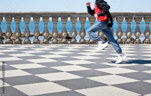 Happy child runs on the famous Mascagni terrace (Italy - Tuscany - Livorno city) - Unrecognizable person