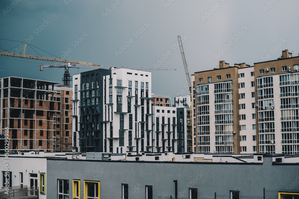 Construction site in Lviv, Ukraine. New residential houses being built. Cloudy stormy skies on the background.