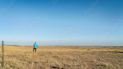 prairie in northern Colorado at early spring with a lonely male figure - Soapstone Prairie Natural Area near Fort Collins