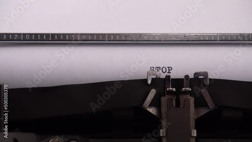 Typing phrase STOP Russian aggressor on retro typewriter. photo