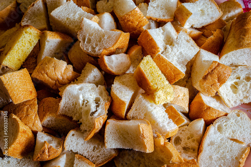 A crouton is a piece of rebaked bread, often cubed and seasoned. photo