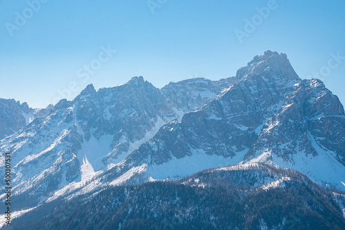 Beautiful majestic kronplatz mountain range. Snow covered idyllic landscape against clear blue sky. Scenic alpine region during winter. © Aerial Film Studio