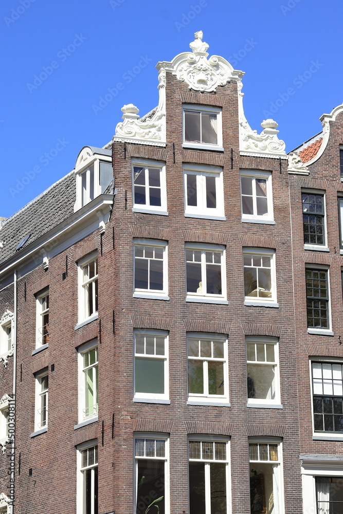 Fototapeta premium Amsterdam Oudezijds Voorburgwal Canal Historic House Facade with Neck Gable, Netherlands