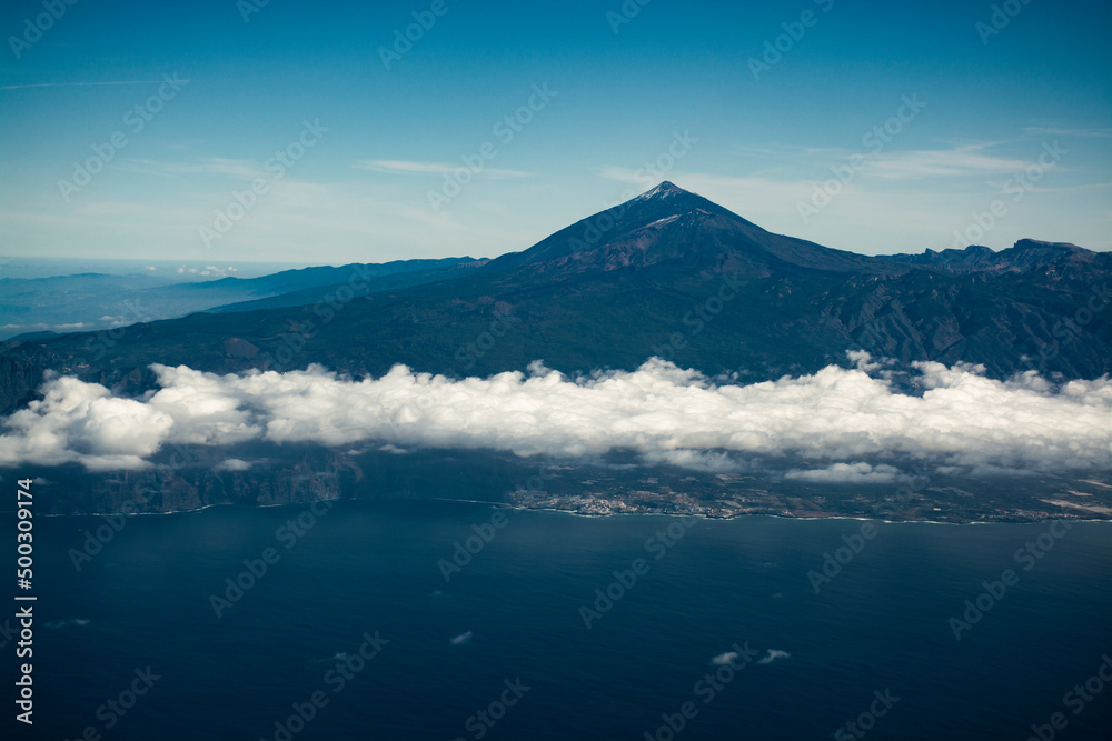 Flying propeller plane above Tenerife island with peak of Mount Teide, volcatic landscape, Canary islands, Spain
