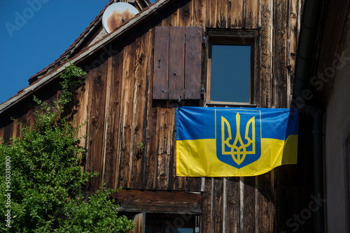 Closeup of ukrainian flag on the house facade in the street