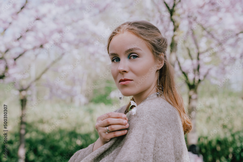 Woman enjoying nature in spring. Relaxation under cherry blossom trees. Woman enjoying life, walking in park with blooming cherry. Happiness concept, relaxation outdoor, spring floral beauty. Woman enjoying nature in spring. Relaxation under cherry blossom trees. Woman enjoying life, walking in park with blooming cherry. Happiness concept, relaxation outdoor, spring floral beauty.