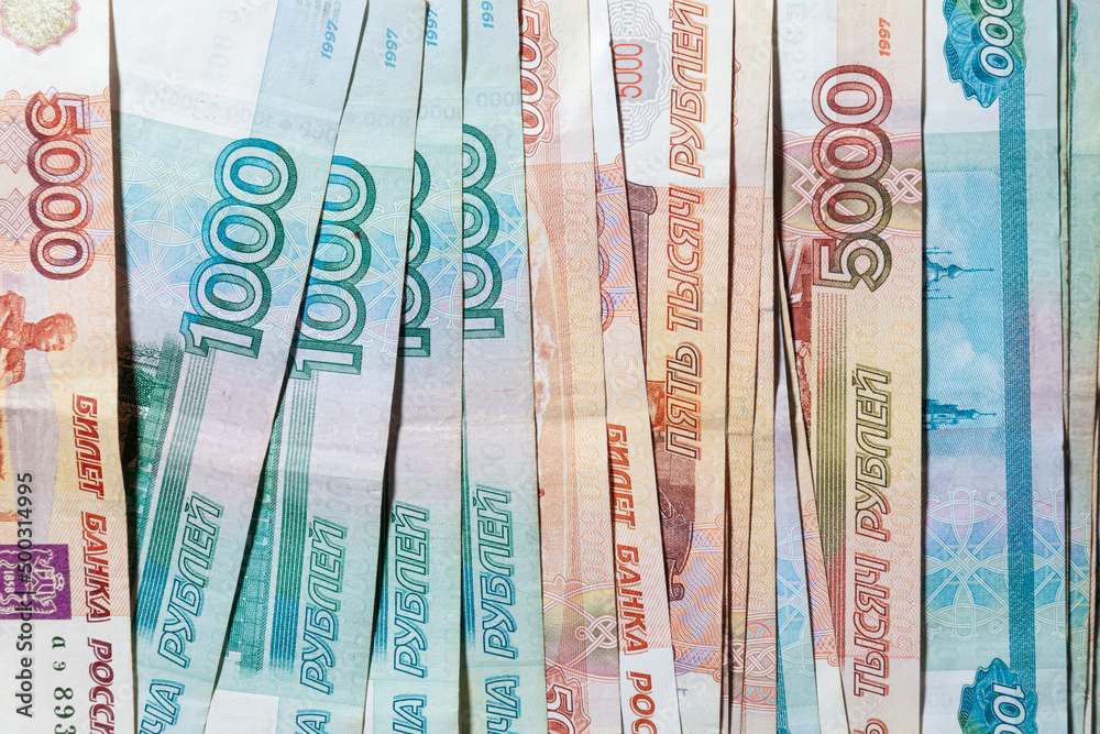 horizontal background of spread out paper money in denominations of one thousand and five thousand Russian rubles horizontal background of spread out paper money in denominations of one thousand and five thousand Russian rubles