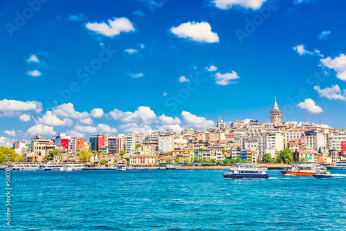 Beyoglu historic district and Galata tower medieval landmark with sightseeing ships. Istanbul, Turkey photo