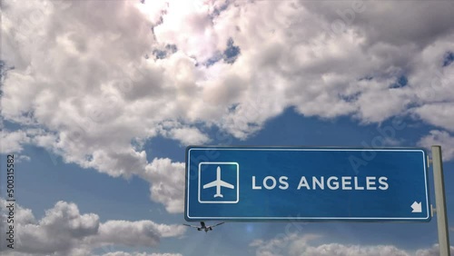 Jet airplane landing in Los Angeles, California, USA, United States. City arrival with airport direction sign. Travel, business, tourism and transport concept.