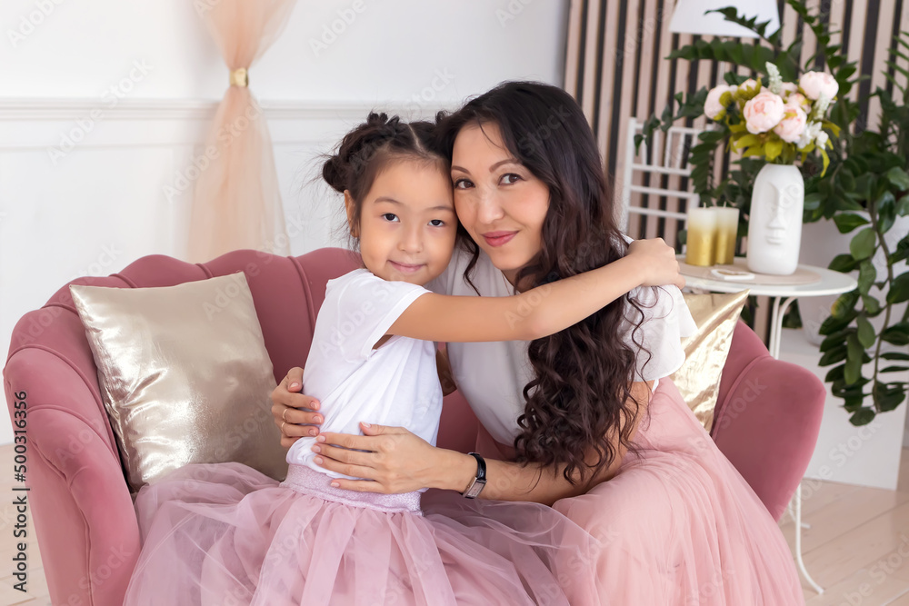 Daughter and mother. Asian appearance. The family is happy. Smiles and laughter. They look at each other. Daughter and mother. Asian appearance. The family is happy. Smiles and laughter. They look at each other.