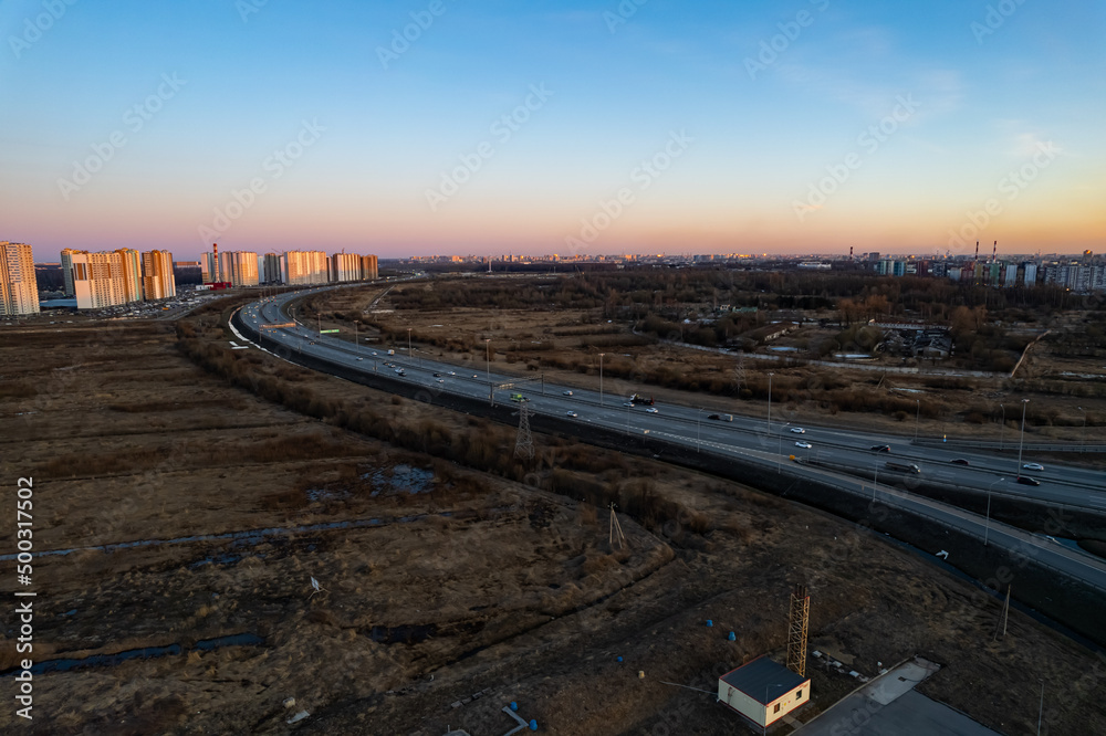 road track near the city new district of the city in the evening at sunset. High quality photo