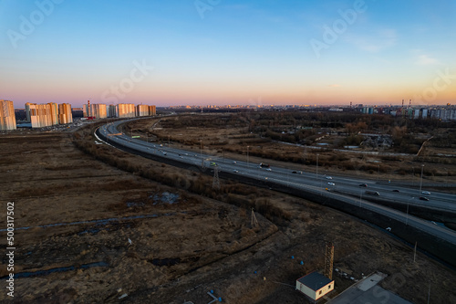 road track near the city new district of the city in the evening at sunset. High quality photo