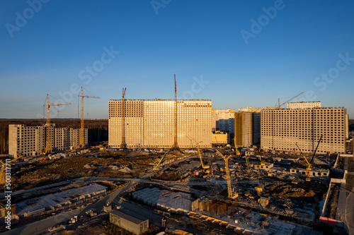 unfinished buildings multi-storey construction equipment on the territory construction site. High quality photo
