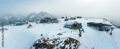 Aerial view of ski stations on snowy landscape. Panoramic view of kronplatz mountain in south tyrol. Scenic tourist attraction during winter. photo