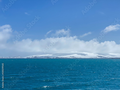 Blue sky and sea  shadow of cloud on snow island