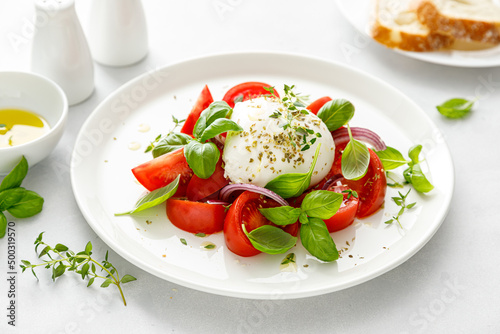 Salad Caprese with tomato, mozzarella and basil, italian food photo