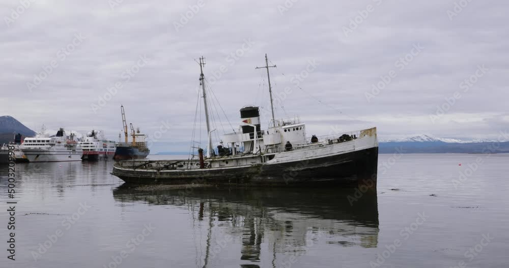 Wreckage. Old abandoned ship run aground in the seashore. View of the ocean, boats and the Andes mountains in the horizon. Wreckage. Old abandoned ship run aground in the seashore. View of the ocean, boats and the Andes mountains in the horizon.