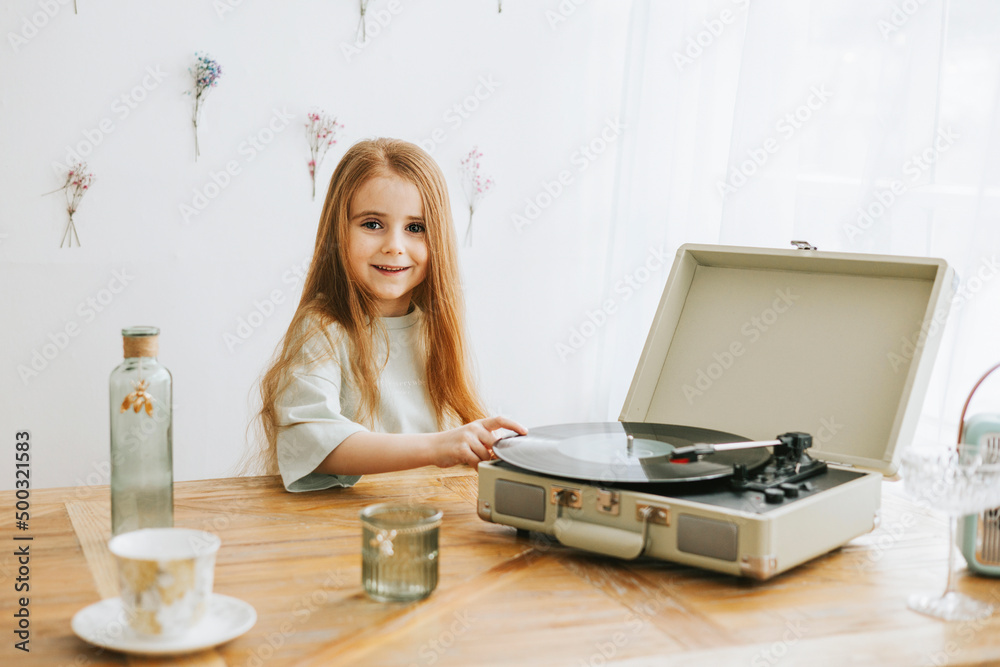 little red haired girl near record player in kitchen of rustic country house with beautiful vintage decor, a happy todler girl in spring, earth tone colors little red haired girl near record player in kitchen of rustic country house with beautiful vintage decor, a happy todler girl in spring, earth tone colors