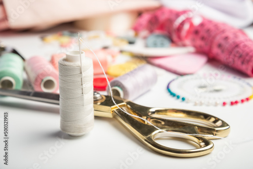 Needle and spool of thread. Sewing hobby background