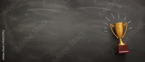 Photo banner of golden trophy over blackboard background