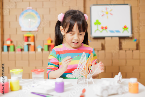 young girl hand make craft for home schooling