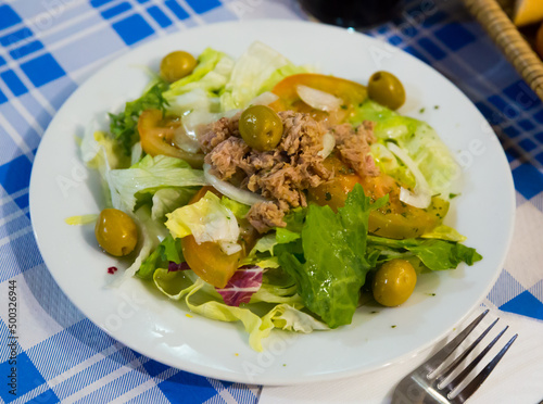 Ensalada manchega, traditional spanish salad with greens, tomatoes, olives and canned tuna