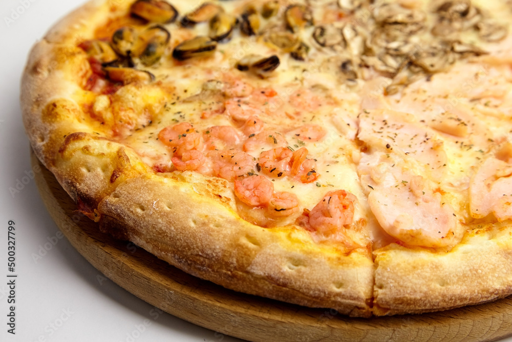 Seafood Pizza mix with mussels and shrimps on wooden cutting board on white
