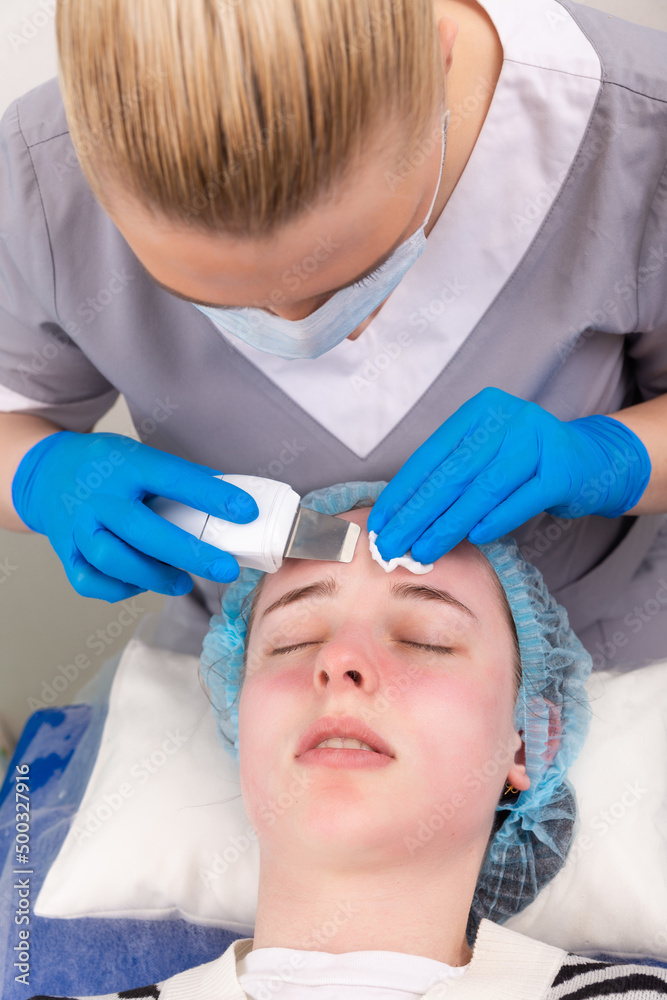 Young woman getting ultrasonic peel skin with skin scrubber. Young woman getting ultrasonic peel skin with skin scrubber.