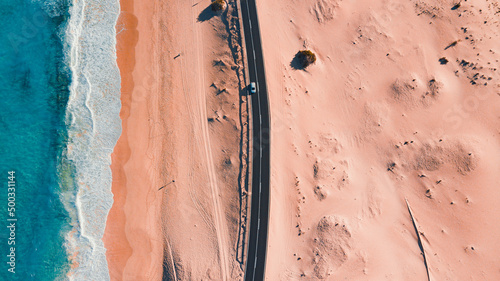 One of the most beautiful destinations in Fuerteventura, the Corralejo dunes. As you walk along this evocative road, on one side you can admire the ocean and on the other the characteristic dunes. photo