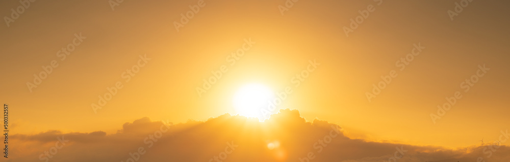 Bright yellow sun over the clouds. Bright orange sunrise on a summer morning. Sunny sky background Bright yellow sun over the clouds. Bright orange sunrise on a summer morning. Sunny sky background