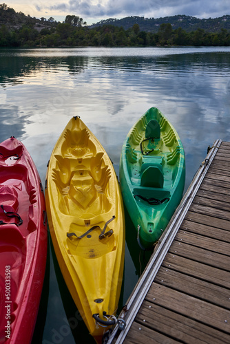 Three Kayaks at Sunset moored to a pontoon on the edge of Lac d'Esparron Provence France