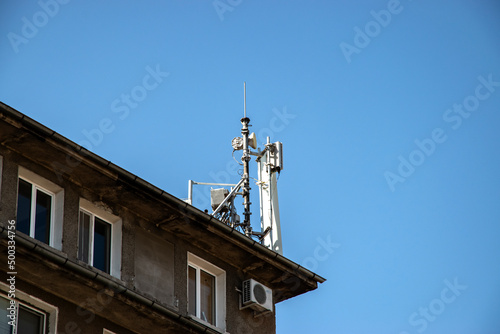 GSM mobile phone antenna tower on house roof