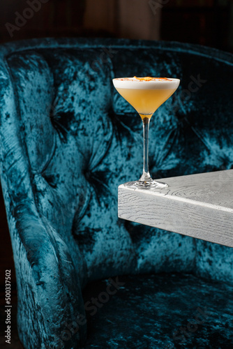 Homemade Pisco sour cocktail. Whiskey Sour in Coupe Glass with ice on gray background. Overhead view, copy space. Advertising for cafe. Bar menu.
