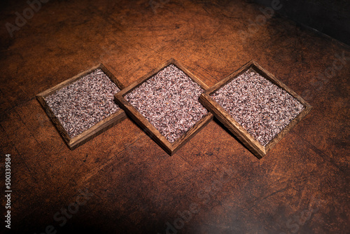 Black rice on square plates in dark light