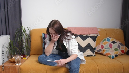 A young woman is waiting for the result of a pregnancy test. The woman found out that she was pregnant. A young woman is pregnant. Early pregnancy