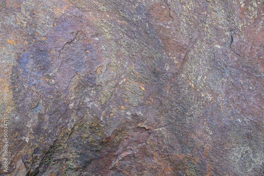 Rough cut rock in dark colors of gray and purple, as a natural background
Rough cut rock in dark colors of gray and purple, as a natural background