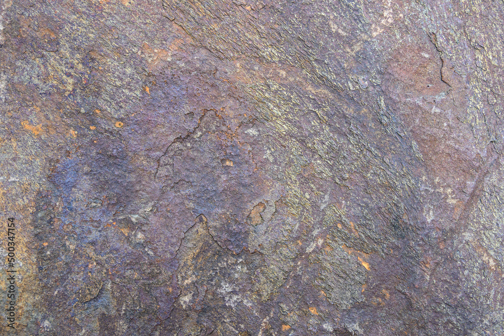 Rough cut rock in dark colors of gray and purple, as a natural background
Rough cut rock in dark colors of gray and purple, as a natural background