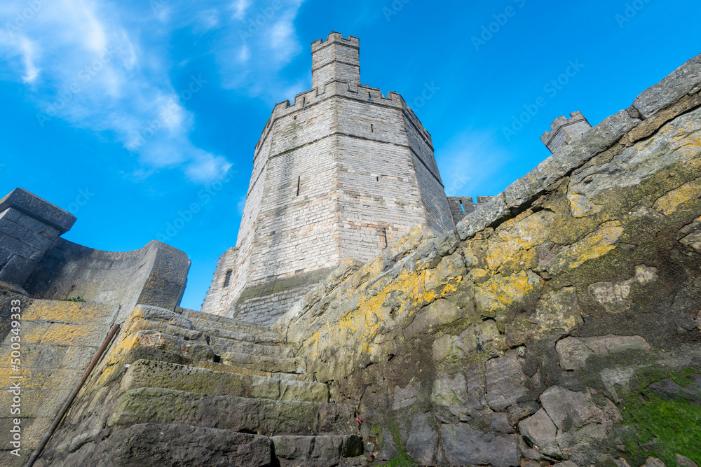 Caernarfon Castle,low angle view of sea wall and steps,from banks of the River Seiont at low tide,Wales,United Kingdom.