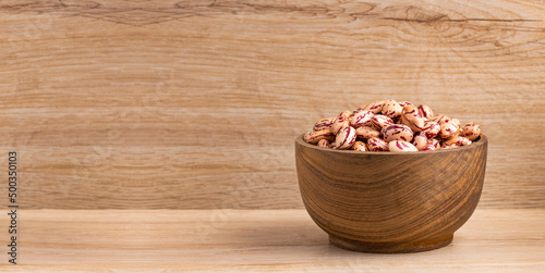 Phaseolus vulgaris - Raw dry pinto beans in wooden bowl