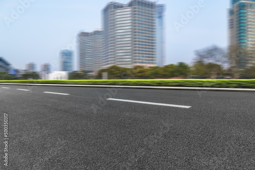 city empty traffic road with cityscape in background.