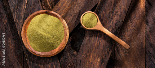 Organic green powder in wooden bowl - Healthy food