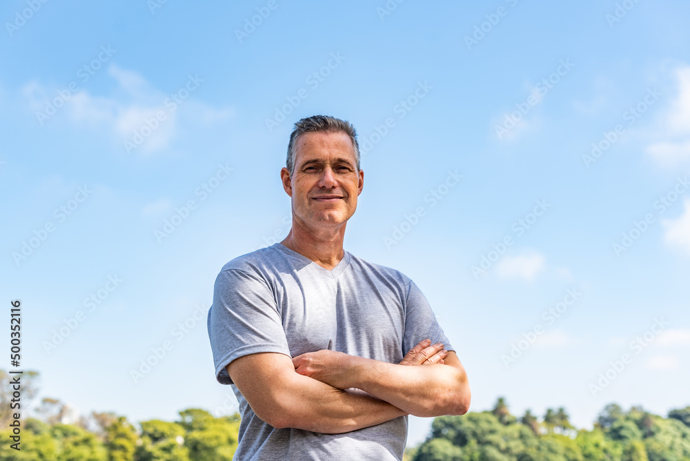 A handsome man with his arms folded and looking at the camera A handsome man with his arms folded and looking at the camera