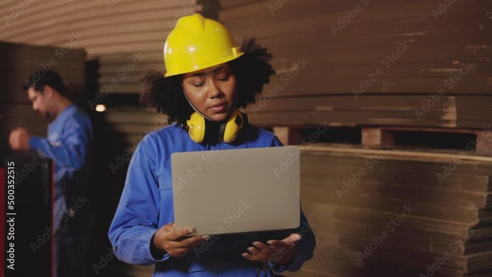 Showing teamwork in the factory . Industrial people and manufacturing labor concept .Asian ,African Woman and man engineer action very happy of their sucessful . Showing teamwork in the factory . Industrial people and manufacturing labor concept .Asian ,African Woman and man engineer action very happy of their sucessful .