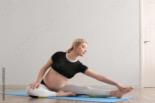 Young pregnant woman doing ...