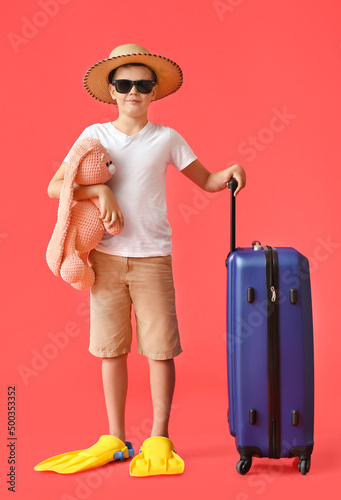 Cute little boy with suitca...