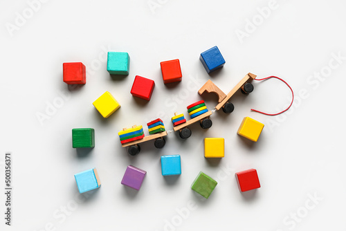 Wooden cubes with blocks on light background