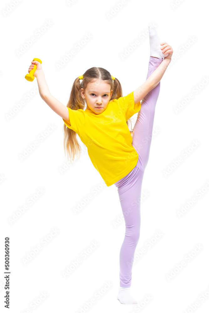 Little cute happy girl with dumbbells performs stretching while standing. Isolated on white background. Little cute happy girl with dumbbells performs stretching while standing. Isolated on white background.