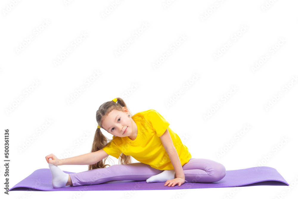 Little cute girl is practicing stretching on a gymnastic mat. Isolated on white background. Little cute girl is practicing stretching on a gymnastic mat. Isolated on white background.